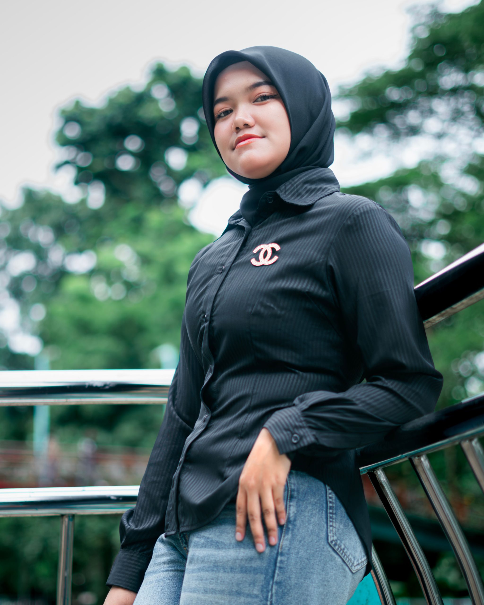 Portrait of a modern Muslim woman in hijab standing outdoors in Banten, Indonesia.